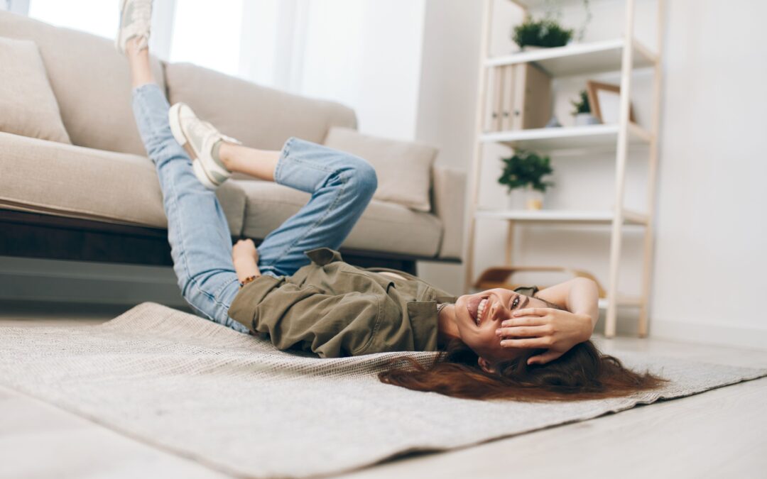 Relaxing on a Cosy Sofa: Happy Woman Enjoying a Peaceful Mental Well-being in a Modern Apartment